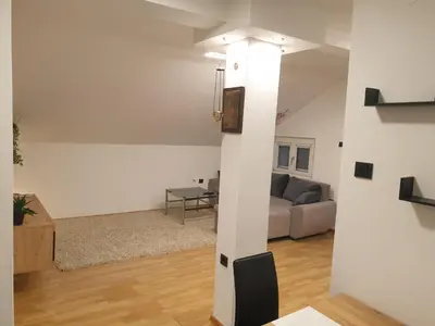 a living room with a couch and a table at Cozy Place in Pavi°evac