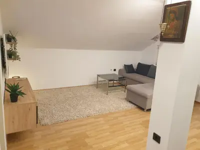 a living room with a couch and a table at Cozy Place in Pavi°evac