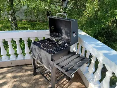 a barbecue grill on a railing on a porch at Cozy Place in Pavi°evac