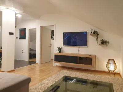 a living room with a flat screen tv on a wall at Cozy Place in Pavi°evac
