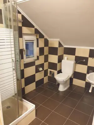 a bathroom with a toilet and a sink at Cozy Place in Pavi°evac