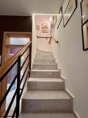 a staircase in a house with a stair railing at Plavi zec apartman Zemun in Belgrade