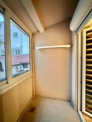 an empty room with a window in a building at Plavi zec apartman Zemun in Belgrade
