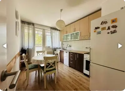 a kitchen with a table and a white refrigerator at Surya in Belgrade