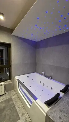 a large bath tub with blue lights on the ceiling at Genex SPA in Belgrade
