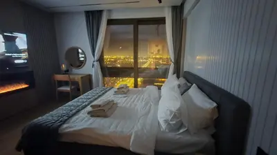 a hotel room with a bed with two towels on it at Genex SPA in Belgrade