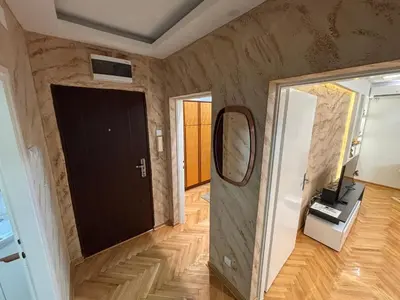 a room with a black door and a mirror at Aktiva Apartments in Belgrade