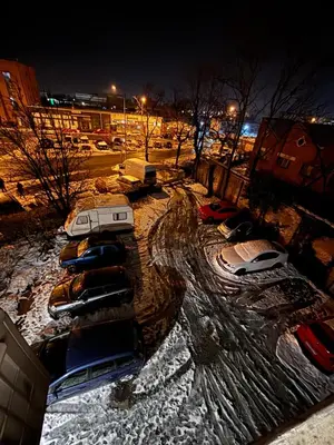 a group of cars parked in a parking lot in the snow at Aktiva Apartments in Belgrade