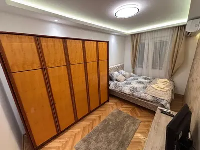 a living room with a large wooden closet at Aktiva Apartments in Belgrade