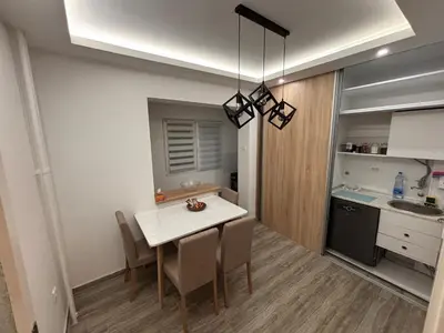 a kitchen and dining room with a table and chairs at Aktiva Apartments in Belgrade