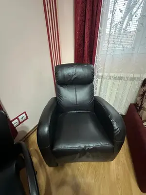a black leather reclining chair in front of a window at Apartment Ruby in Belgrade