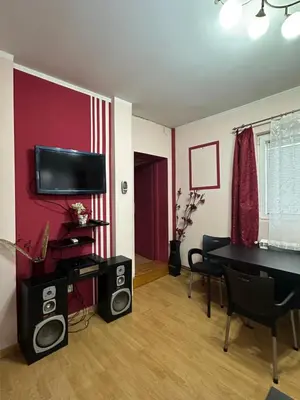 a living room with a table and two speakers at Apartment Ruby in Belgrade