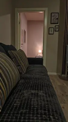 a large bed in a room with a lamp at AG Cozy Apartment in Belgrade