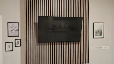 a flat screen tv hanging on a wall at AG Cozy Apartment in Belgrade