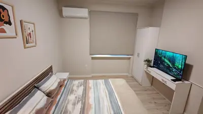a white living room with a flat screen tv at AG Cozy Apartment in Belgrade
