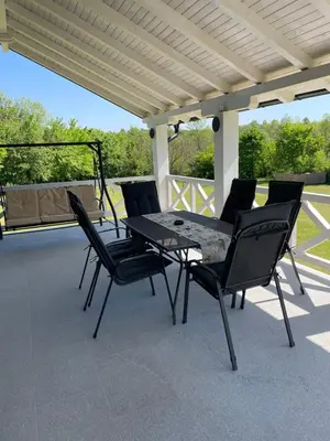 a black table and chairs on a patio at Moje srećno mesto in Arandjelovac
