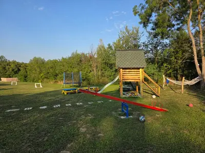 a play area with a playground with a play house at Moje srećno mesto in Arandjelovac