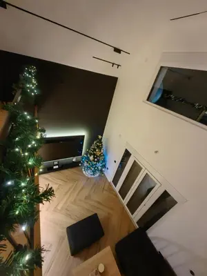 a living room with a christmas tree and a television at Moje srećno mesto in Arandjelovac