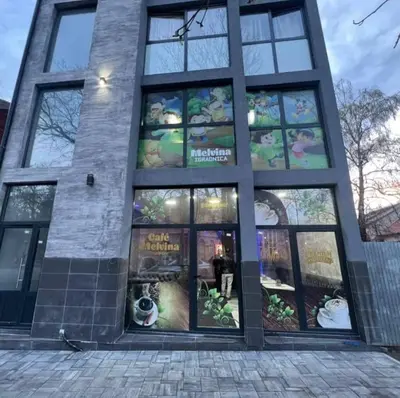 a large building with a dog in the window at Melvina in Pančevo