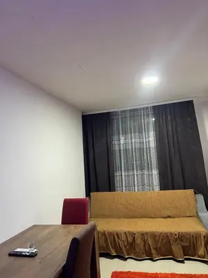 a bedroom with a bed and a table and a window at Melvina in Pančevo