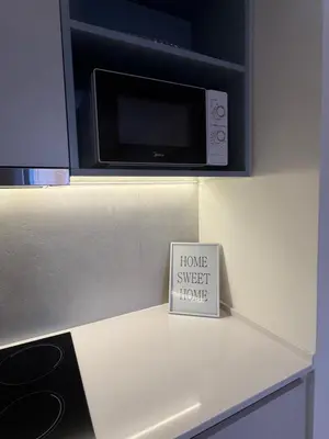 a sign sitting on top of a counter with a microwave at Dockside Belgrade Waterfront in Belgrade