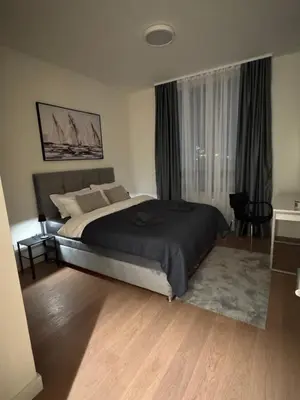 a bedroom with a large bed and a window at Dockside Belgrade Waterfront in Belgrade