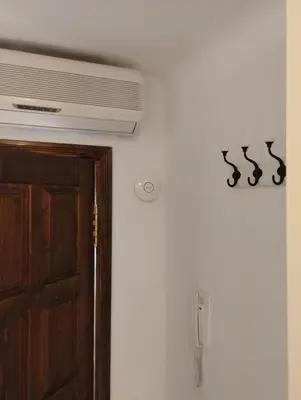 a room with a door and a air conditioner at Pevac, Rooster, apartment in Belgrade