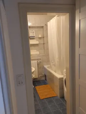 a bathroom with a tub and a toilet and a sink at Pevac, Rooster, apartment in Belgrade