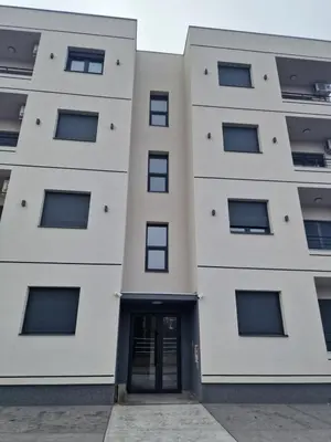 a building with a door in front of it at Lux apartmani na Ledinama in Ledine