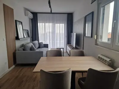 a living room with a table and a couch at Lux apartmani na Ledinama in Ledine