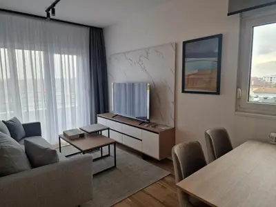 a living room with a couch and a tv at Lux apartmani na Ledinama in Ledine