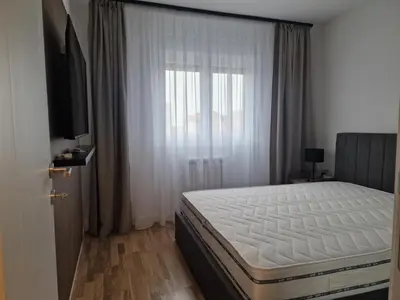 a bedroom with a white bed and a window at Lux apartmani na Ledinama in Ledine