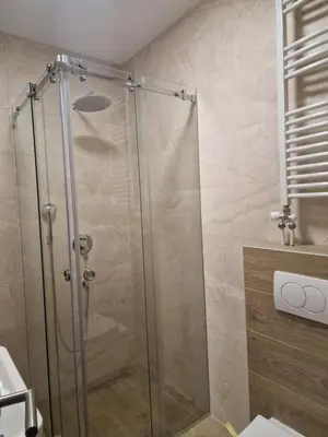 a shower with a glass door in a bathroom at Lux apartmani na Ledinama in Ledine