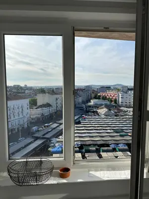 two windows in a room with a view of a parking lot at Kalenić Sky in Belgrade