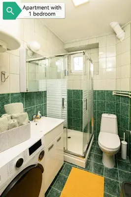 a bathroom with a toilet and a glass shower at Top House Belgrade in Belgrade