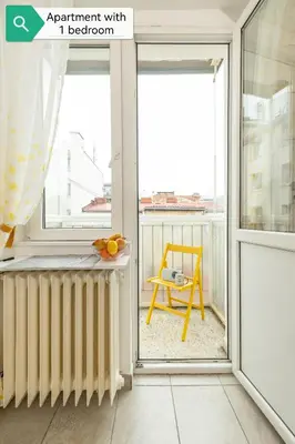 an apartment with a balcony with a yellow chair at Top House Belgrade in Belgrade