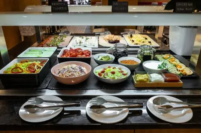 a buffet line with many different types of food at Nobel Palace Hotel in Belgrade