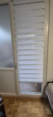 a window with a blind in a room with a wooden floor at Two Sister in Belgrade