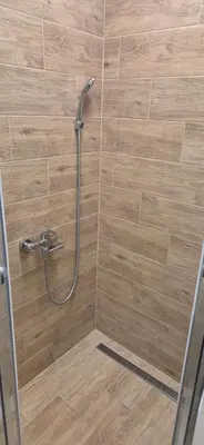 a shower with a hose in a bathroom at Two Sister in Belgrade