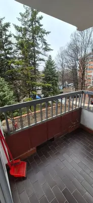 a red chair sitting on top of a balcony at Two Sister in Belgrade