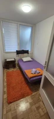 a small room with a bed and a window at Two Sister in Belgrade
