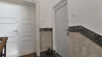 a room with two white doors and a fireplace at Center 1 Queen bed Sofa Additional living area in Belgrade