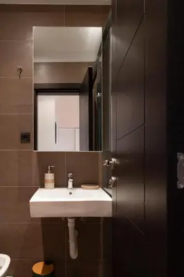 a bathroom with a white sink and a mirror at Charming Duplex in Belgrade in Belgrade