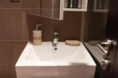 a bathroom sink with a faucet on top of it at Charming Duplex in Belgrade in Belgrade