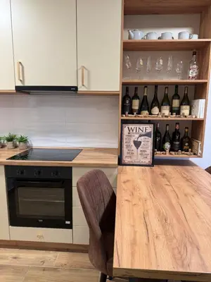 a kitchen with a table with a bunch of wine bottles at Wine story in Irig