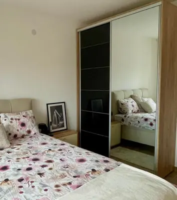 a bedroom with a large mirror next to a bed at Wine story in Irig