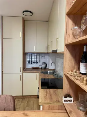 a kitchen with white cabinets and a sink at Wine story in Irig