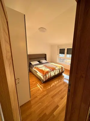 a bedroom with a bed in the middle of a room at Apartman Tiffany in Belgrade