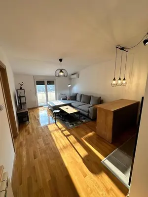 a living room with a couch and a table at Apartman Tiffany in Belgrade