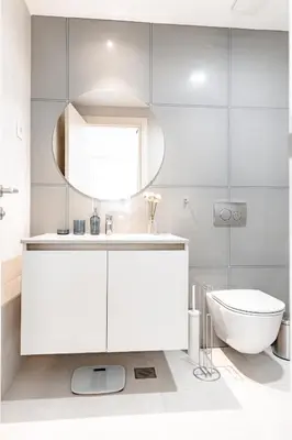 a white bathroom with a sink and a toilet at Aglaya Paris - Lux 2 Bedroom Apartment in Belgrade